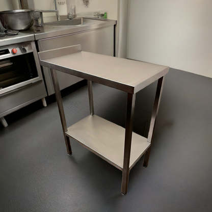 A stainless steel commercial kitchen table with an optional undershelf, situated in a kitchen environment.